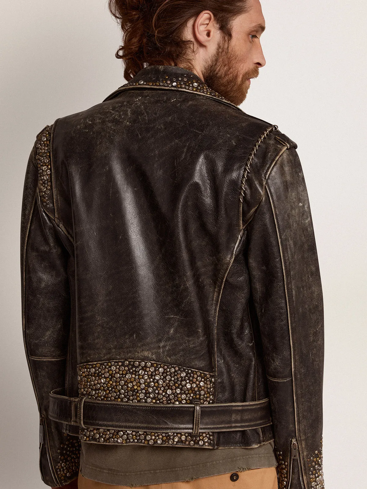 Men's leather biker jacket with hammered studs and adhesive tape